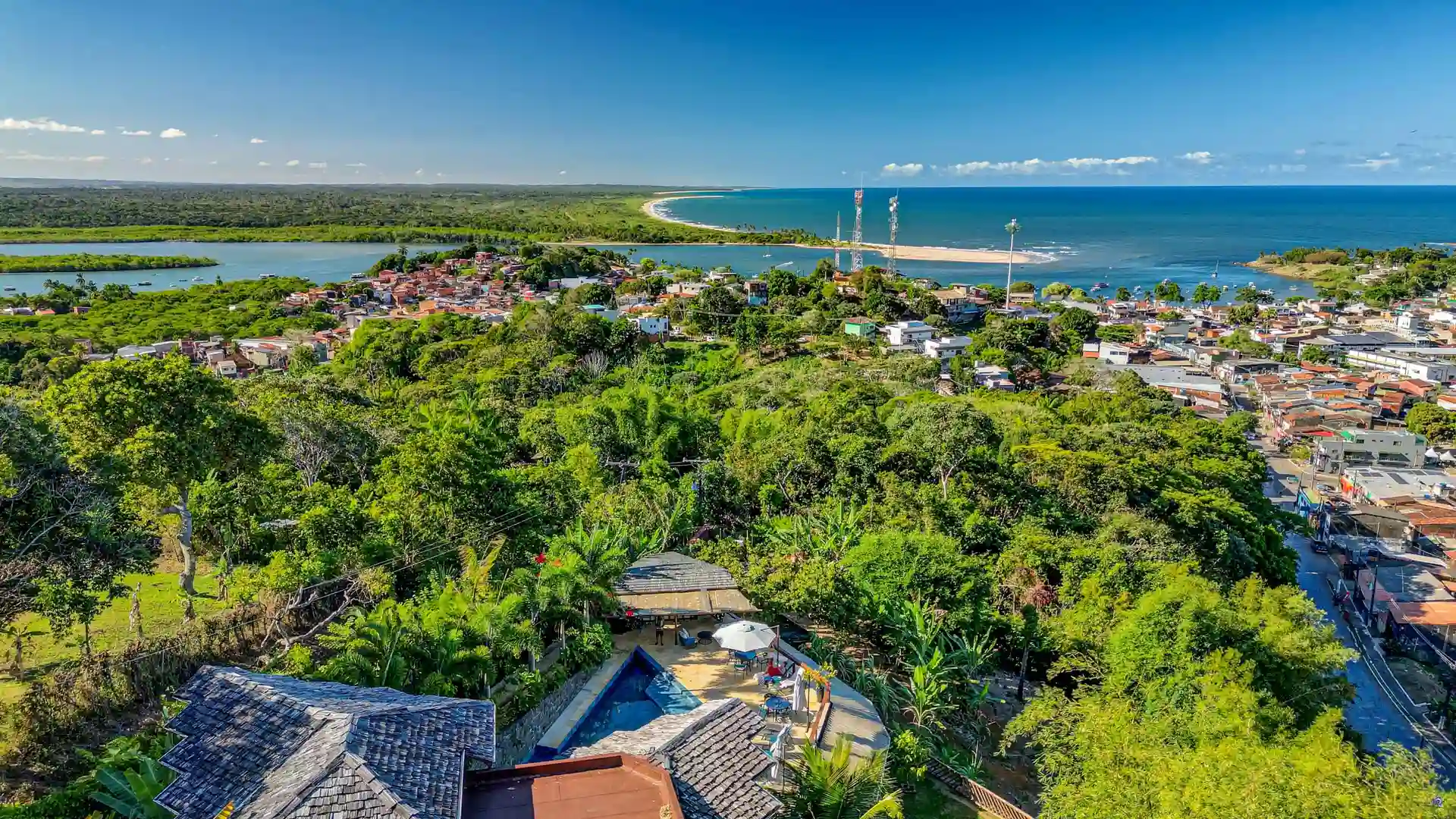 Chocolate Hotel from above, at the entrance to Itacaré, with the village, the mouth of the Contas River and the line of beaches behind
