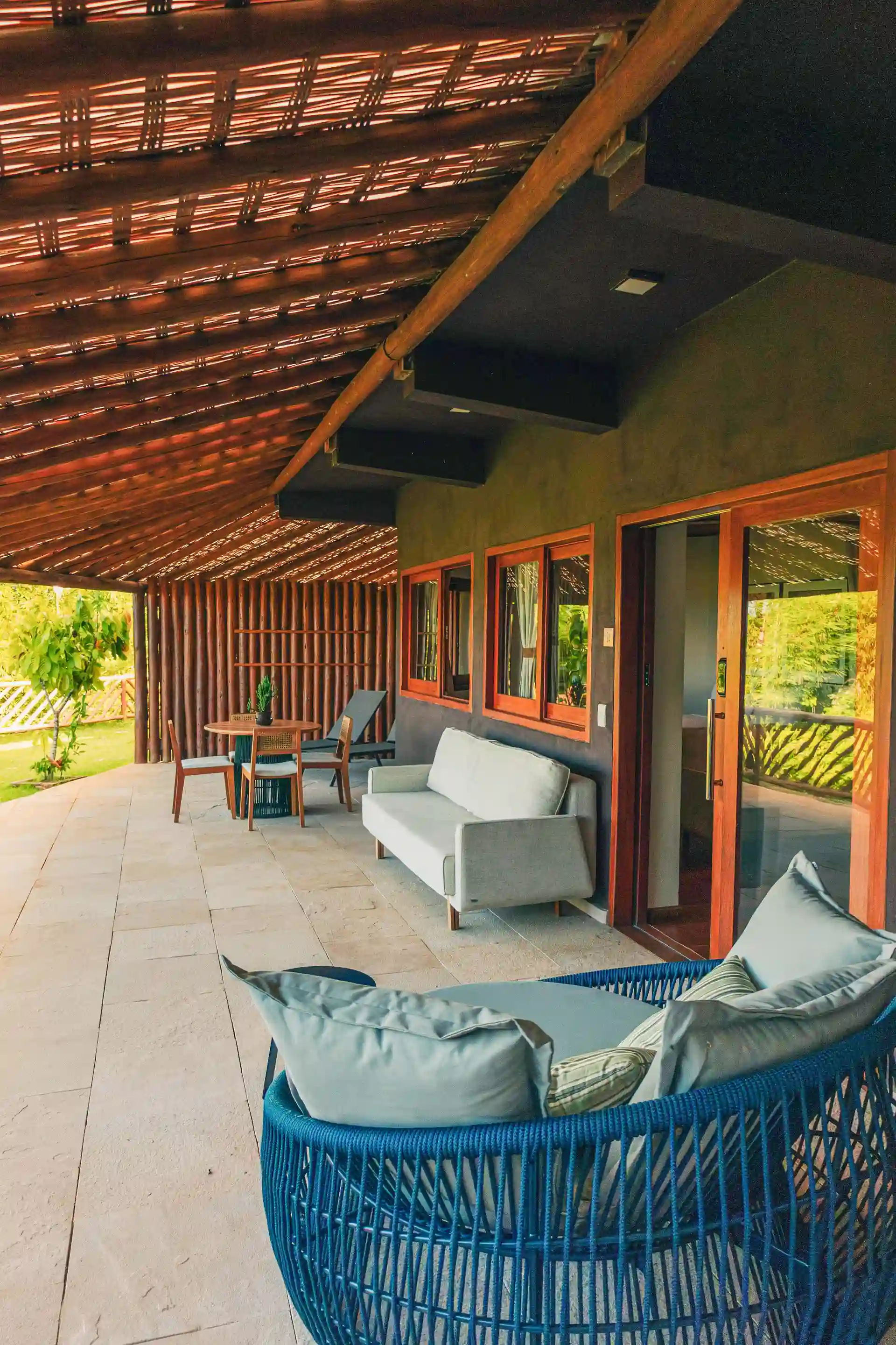 The covered balcony of the Grand Cru suite, with the garden in front