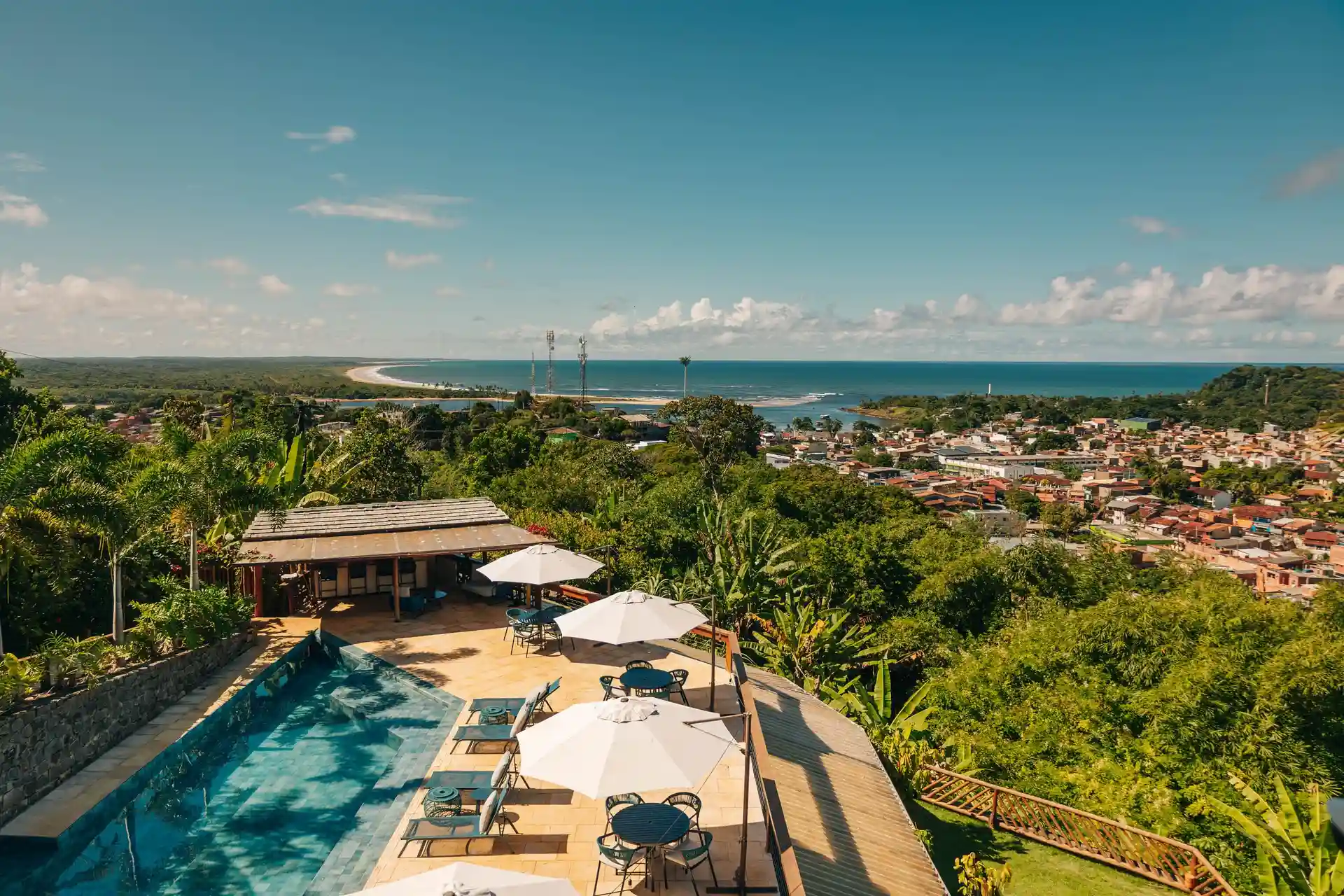 A piscina do Chocolate Hotel vista do alto, com a vila de Itacaré e o mar ao fundo