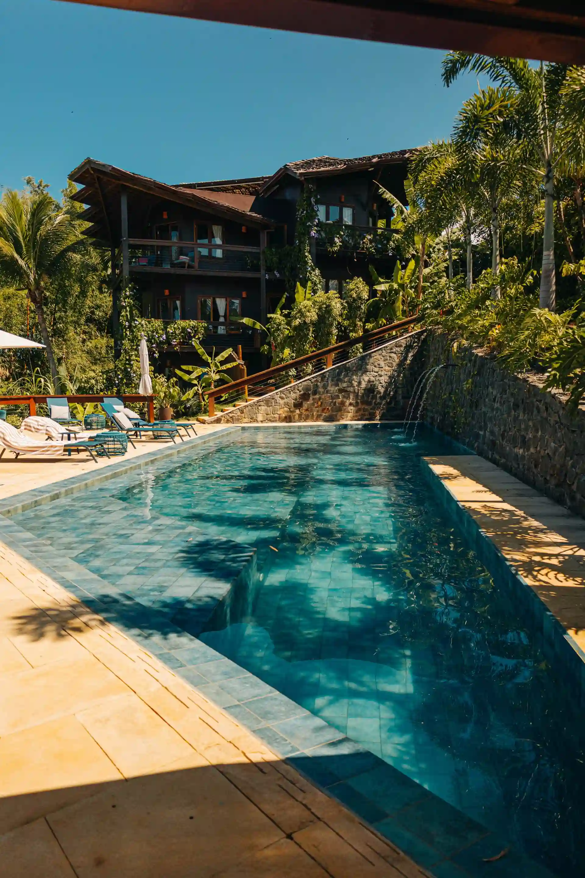 The long lane of the pool, with the pergola and the forest around